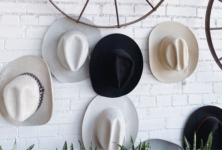 Hats hanging on wall to represent juggling services with company